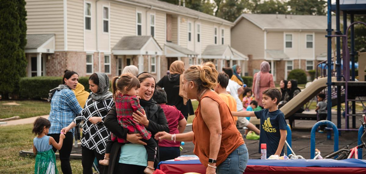 People in front of playground with small children