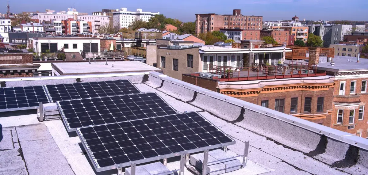Roof with solar panels and view of city skyline