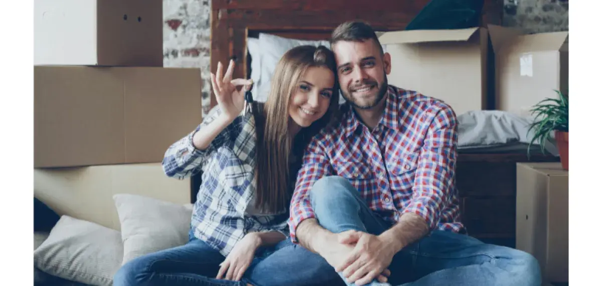 Stock image of couple smiling, holding keys