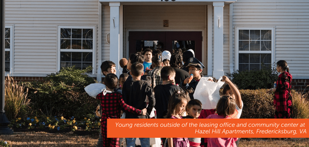 Young residents outside of the leasing office and community center at Hazel Hill Apartments, Fredericksburg, VA