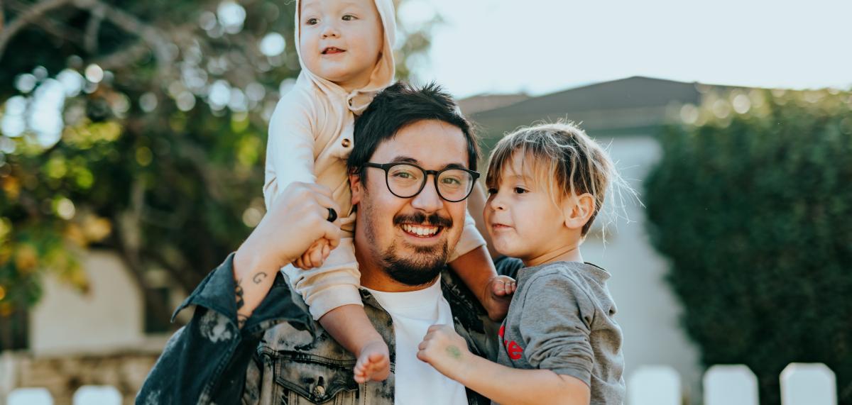 Parent holding two kids