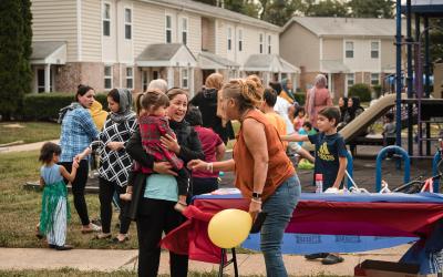 People in front of playground with small children