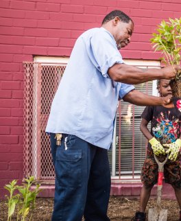 Young resident learns about farming from community member