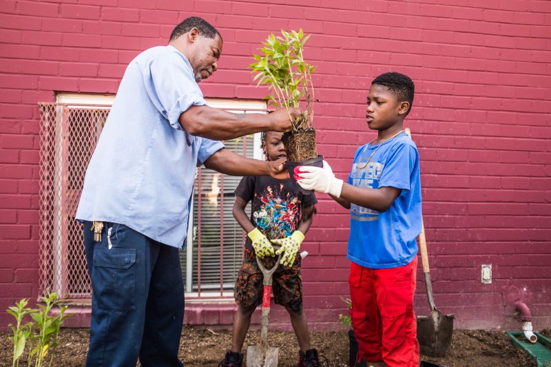 Young resident learns about farming from community member