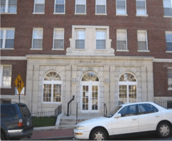 Exterior of Meridian Manor apartments with parked cars